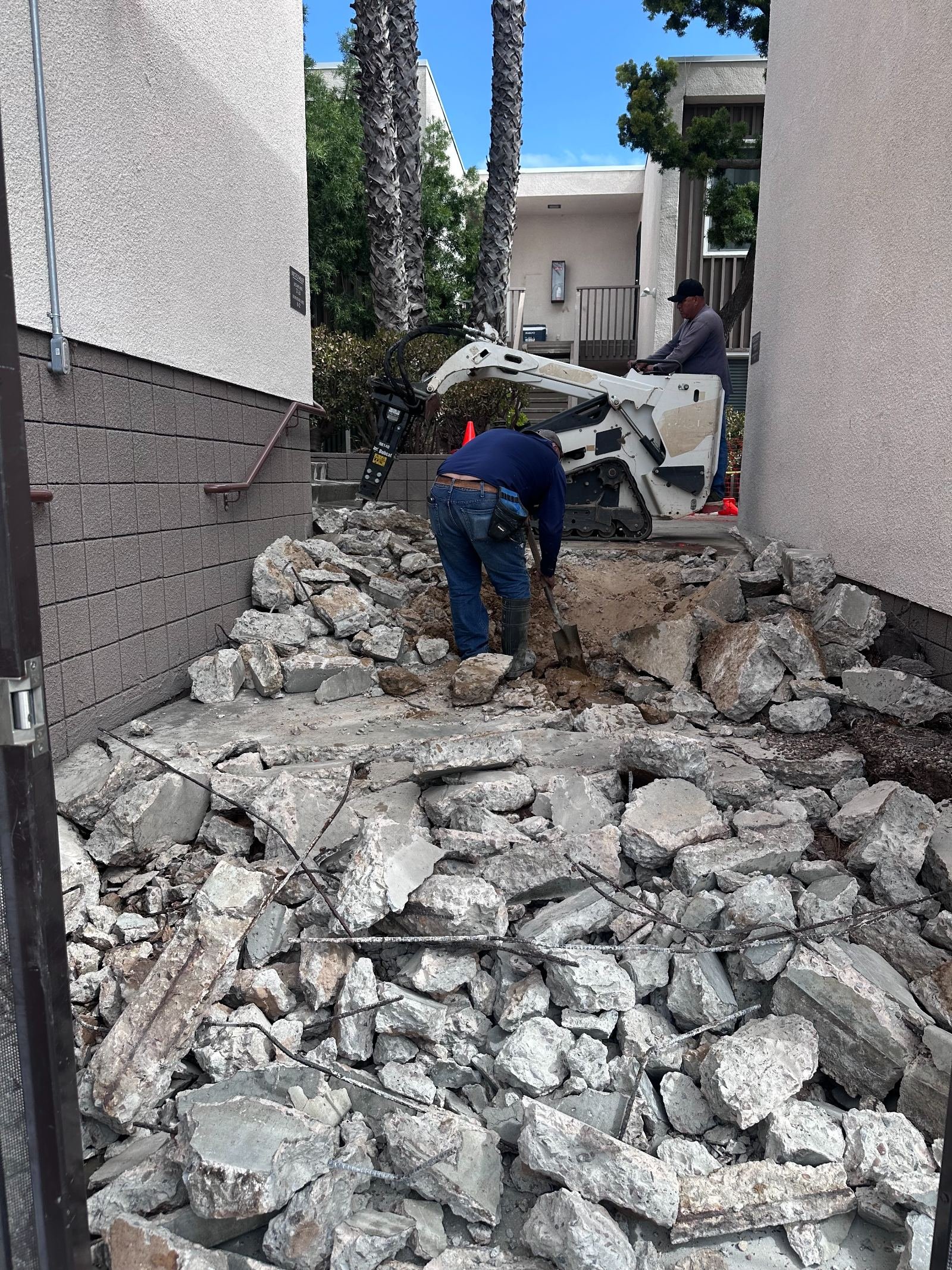 Cordada Construction crew breaking out concrete and preparing the base for a new pour in Vista, California