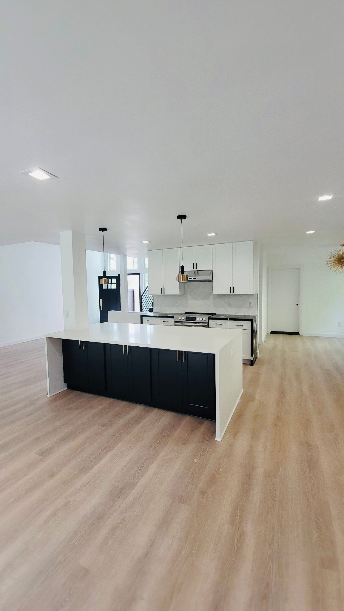 Open-concept kitchen remodel with waterfall quartz island in Vista, California